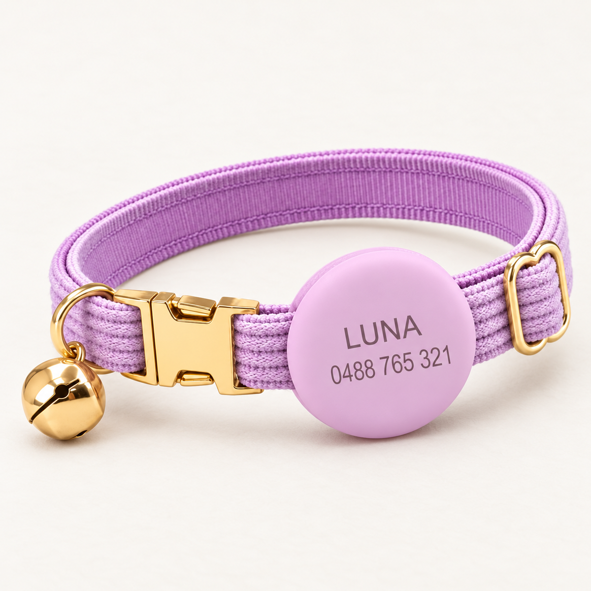 Lilac | Corduroy cat collar with matching silicone AirTag holder, gold non-breakaway buckle and removable bell, soft natural studio hero.